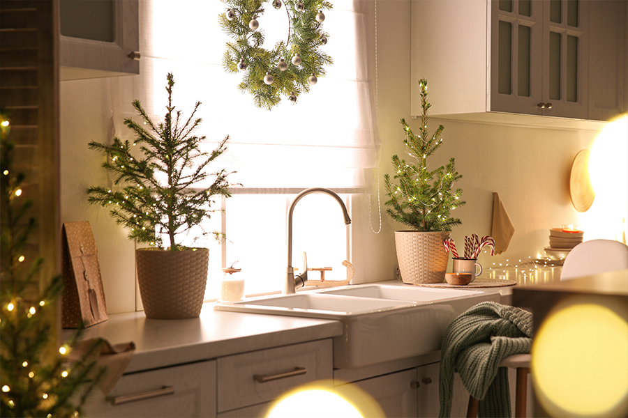 A cozy kitchen in Highland, IL decorated for Christmas with beautiful greenery & string lights.